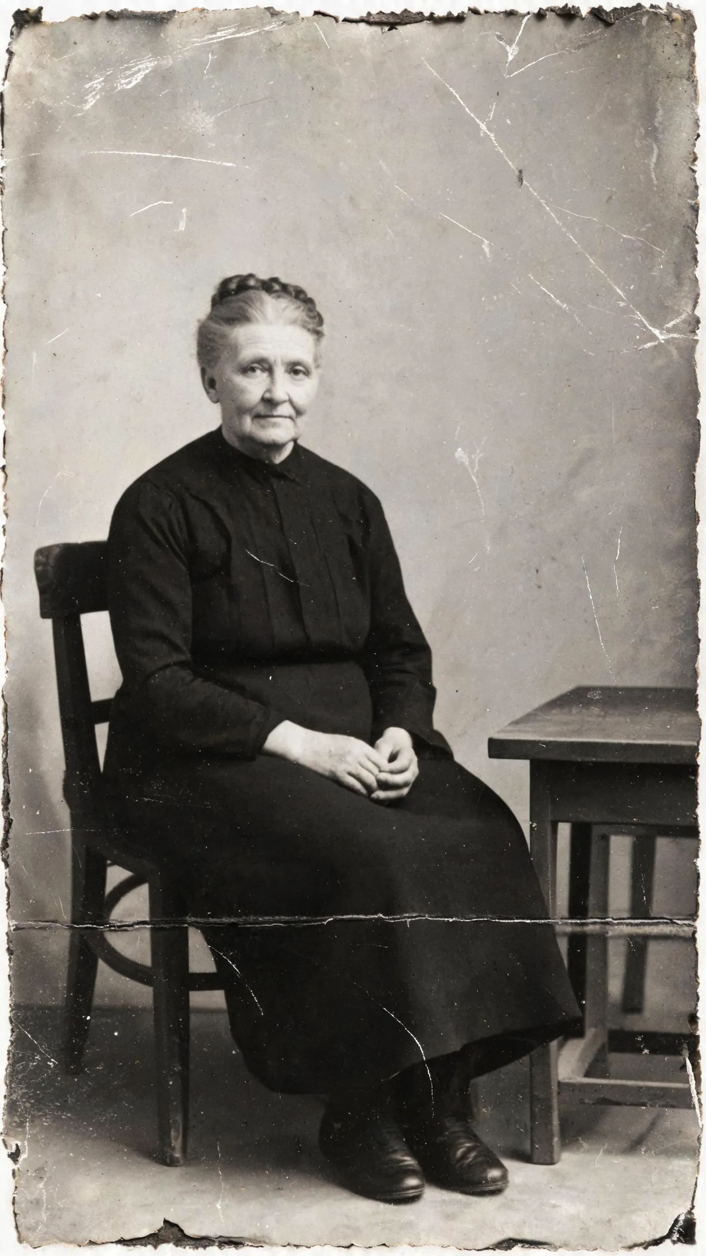 Damaged black-and-white historical portrait before AI restoration